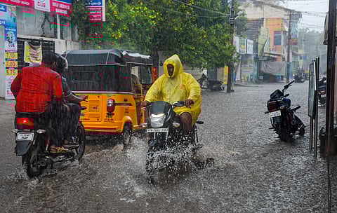 Vehicles move through a waterlogged road amid rain, at Nagercoil in Kanniyakumari district, Tamil Nadu, Saturday, Oct. 25, 2025.