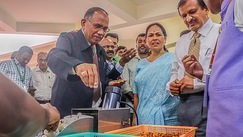 Minister Shobha Karandlaje observes the cocoon-silkworm separating device at NIMHANS Convention Centre.