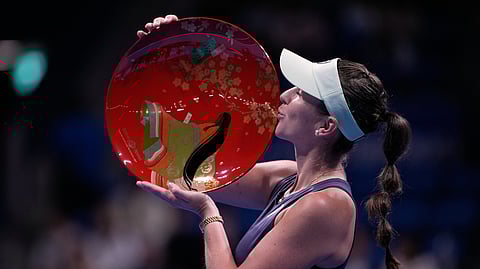 Switzerland's Belinda Bencic holds the champion trophy after winning against Czech Republic's Linda Noskova in the final match of the Pan Pacific Open women's tennis tournament at Ariake Coliseum, in Tokyo, Sunday, Oct. 26, 2025.