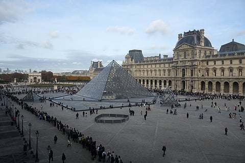 People queue outside the Louvre museum three days after historic jewels were stolen in a daring daylight heist, Wednesday, Oct. 22, 2025, in Paris.