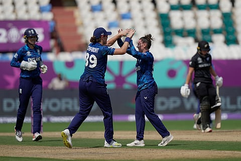 England's Linsey Smith celebrates with teammates the wicket of New Zealand's Isabella Gaze.