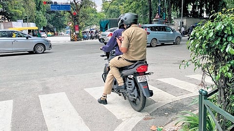 Two policemen on a bike seen obstructing a zebra crossing on Infantry Road