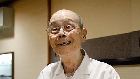 In this photo released by Bureau of Social Welfare, Tokyo Metropolitan Government, sushi legend Jiro Ono talks to reporters, who gathered in front of his restaurant to celebrate his 100th birthday in Tokyo, on Sept. 18, 2025.