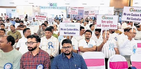 Rice millers holding banners at the meeting in Bargarh on Sunday evening.