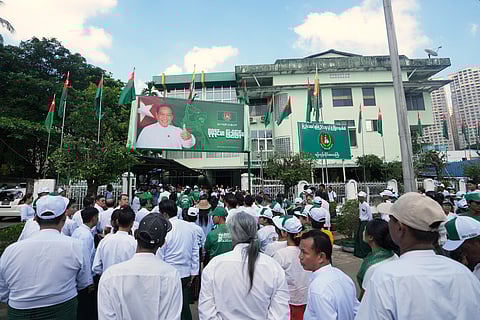 Members of the military-backed Union Solidarity and Development Party (USDP) gather for the opening ceremony of the party's slogan poster during the first day of the election campaign for the upcoming general election at their Yangon region party's headquarters Tuesday, Oct. 28, 2025, in Yangon, Myanmar.