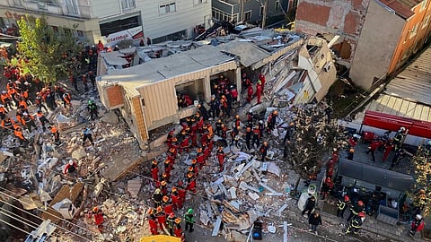 Firefighters and rescue teams search for trapped people after a residential building that collapsed in Gebze, Turkey.