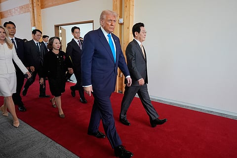 President Donald Trump, center, and South Korean President Lee Jae Myung, right, attend a high honor ceremony at the Gyeongju National Museum in Gyoeongju, South Korea.