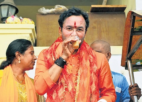 Union minister G Kishan Reddy enjoys a cup of tea during a poll campaign in Yousufguda on Thursday.