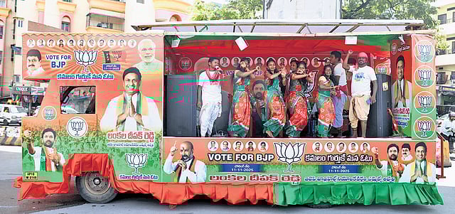 Cultural performers perform on a campaign vehicle of BJP party urging voters to vote for BJP ahead of the upcoming Jubilee Hills byelections near Yousufguda Metro station in Hyderabad.