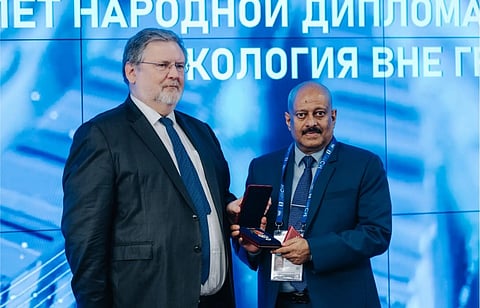 Russian house director Ratheesh C Nair being presented with a badge of honour at a function at Russian Geographical Society headquarters in Moscow