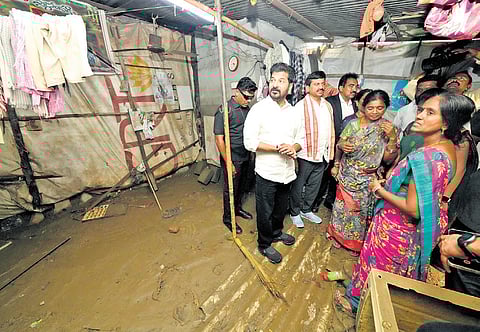Chief Minister A Revanth Reddy interacts with the residents of flood-affected areas in Hanamkonda on Friday.