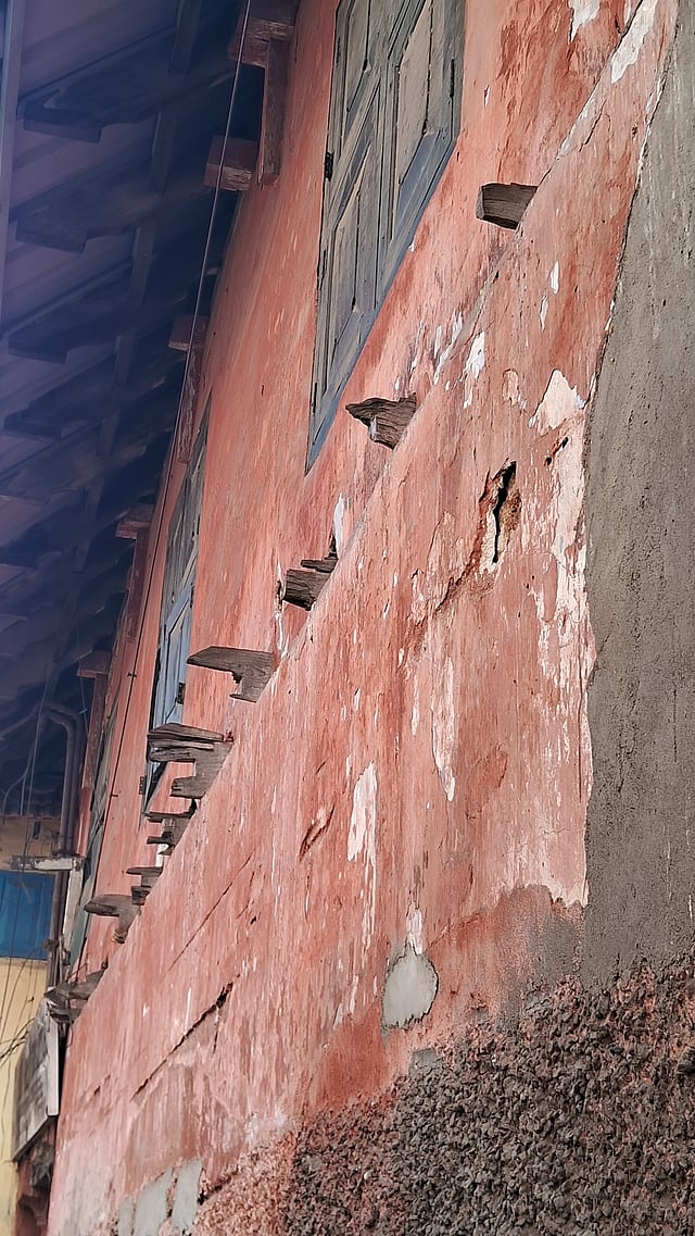 Wooden trusses protruding from an old building