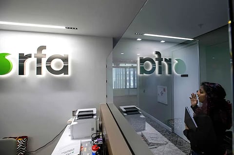 A woman walks past the empty receptionist desk at Radio Free Asia, April 1, 2025, in Washington.