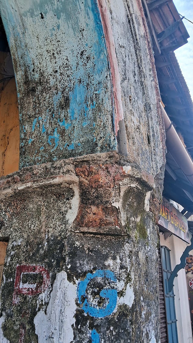 Multiple coats of paint peeling off from the walls of a warehouse