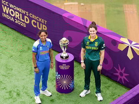 India captain Harmanpreet Kaur (L) and Laura Wolvaardt pose besides the Trophy