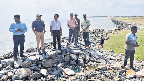 Kendrapara collector Raghuram R Iyer inspecting the seawall with senior officials.