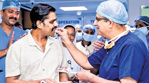 Dr Jose Chacko Periappuram shares a piece of cake with Ajmal.