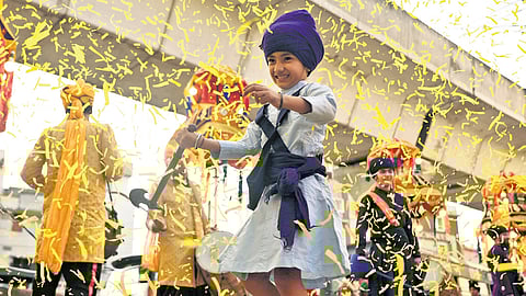 A Sikh kid a man and a woman (display Gatka skills during the Nagar Keertan as part of the 556th Prakash Puram of Guru Nanak Dev in Secunderabad on Saturday.