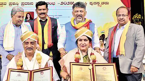 Actors Prakash Raj and Vijayalakshmi Singh receive the Rajyotsava award in the presence of Chief Minister Siddaramaiah, DCM DK Shivakumar and Kannada and Culture Minister Shivaraj Tangadagi during the 70th Kannada Rajyotsava celebrations in Bengaluru on Saturday.