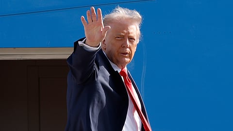 US President Donald Trump waves from the stairs of Air Force One as he boards upon his arrival at Joint Base Andrews, Md., Friday, Oct. 31, 2025, en route to his Mar-a-Lago estate in Palm Beach, Fla.