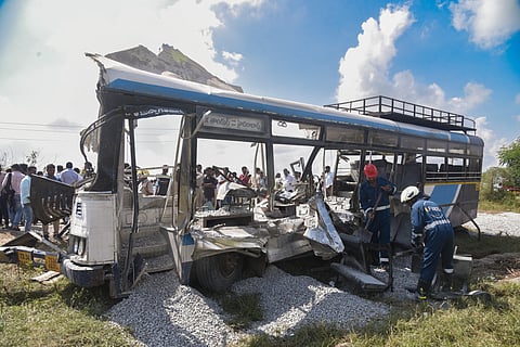 Fire department personnel at the site after a tipper lorry carrying gravel collided head-on with a public transport bus, in Rangareddy district, Telangana, Monday, Nov. 3, 2025.
