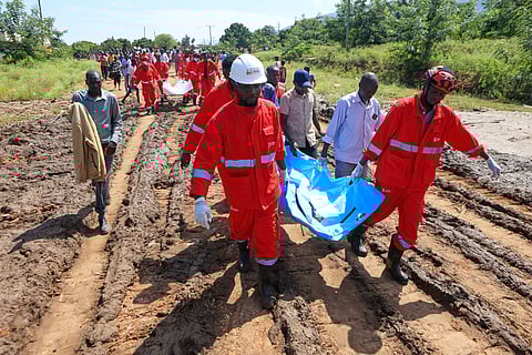 Rescue teams carry bodies of victims of a landslide in the hilly area of Chesongoch in Elgeyo Marakwet county, western Kenya, Sunday, Nov. 2, 2025.