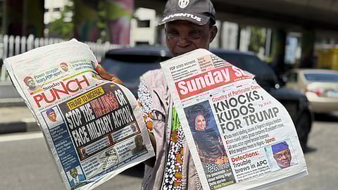 A vendor sells local newspapers with headlines referring to US President Donald Trump's comments about Nigeria, on the street of Lagos, Nigeria, Sunday, Nov. 2, 2025.