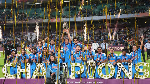 India's players pose with the winning trophy after their win over South Africa in the ICC Women's Cricket World Cup final match in Navi Mumbai, India, Sunday, Nov. 2, 2025.