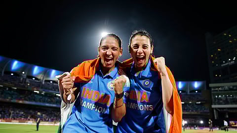 India's captain Harmanpreet Kaur (L) celebrates with her deputy Smriti Mandhana after winning the ICC Women's Cricket World Cup final match between India and South Africa in Navi Mumbai, India, Sunday, Nov. 2, 2025.