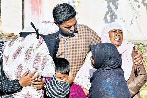 Family members of those who died in the accident mourn outside a mortuary in Chevella, Rangareddy district, on Monday.