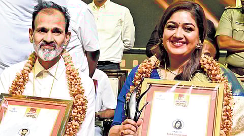 Veteran actor Raghavendra Rajkumar and actress Meghana Raj pose with the state best actor and best actress award, in Mysuru on Monday.