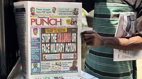 A vendor sells local newspapers with headlines referring to US President Donald Trump's comments about Nigeria on the streets of Lagos, Nigeria, Sunday, Nov. 2, 2025.