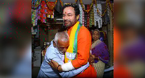 An elderly person hugs Union minister G Kishan Reddy during his door-to-door campaign at Erragadda on Monday.