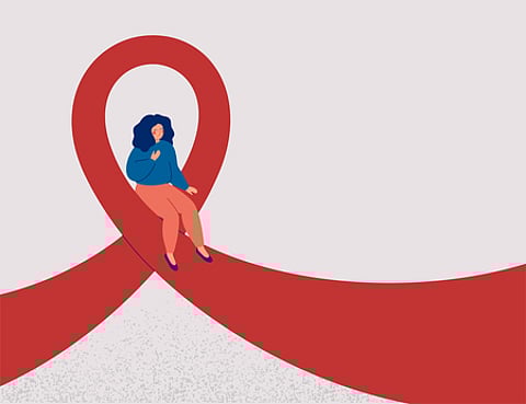 A woman sits on pink or red Ribbon. Raising awareness about the treatment and medical exam of breast cancer