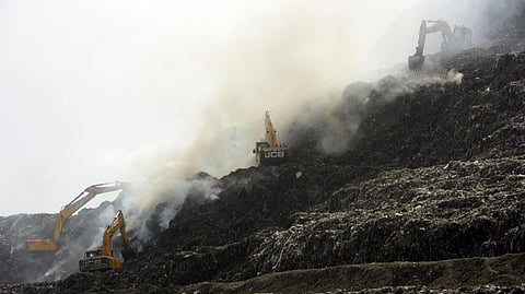 JCB machine trying to control fire at Ghazipur landfill site.