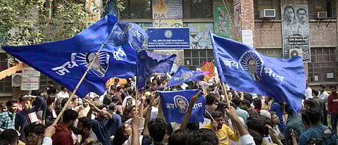 Supporters campaign in front of the polling booth for JNU Students Union Election in New Delhi on Tuesday.