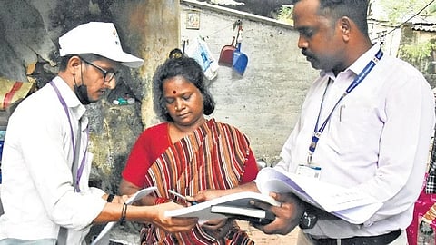 Officials carrying out door-to-door verification as part of the Special Intensive Revision of electoral rolls at Samy Street in Egmore on Tuesday.