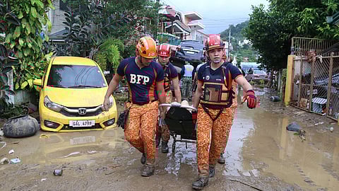 In this photo provided by the Philippine Red Cross, the Water Search and Rescue Team assists individuals trapped on a roof in the Talamban barangay of Cebu, Philippines, Tuesday, Nov. 4, 2025