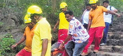 Fire services personnel carrying Sujata after her rescue on Wednesday