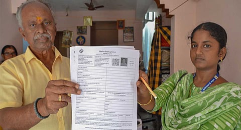 As part of the special intensive voter list revision ahead of the 2026 Assembly elections, a booth-level officer verifies voter details during a door-to-door survey in Tirunelveli.