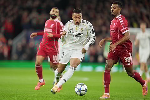 Real Madrid's Kylian Mbappe in action by Liverpool's Ryan Gravenberch during the Champions League soccer match between Liverpool and Real Madrid in Liverpool, England, Tuesday, Nov. 4, 2025.