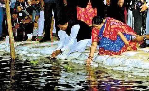 Chief Minister Mohan Charan Majhi, with his wife Priyanka Marandi sailing leaf boats in the Mahanadi before unveiling Balijatra 2025 at Cuttack on Wednesday