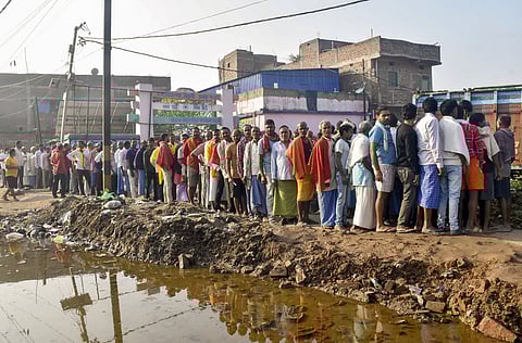 Voters waiting in a queue to cast votes at a polling station during the first phase of the Bihar Assembly elections, in Patna, Thursday, Nov. 6, 2025.