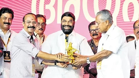 Travancore Devaswom Board president P S Prasanth handing over an Ayyappa Idol to Chief Minister Pinarayi Vijayan during the inauguration of the Global Ayyappa Sangamam at Pampa on Saturday.