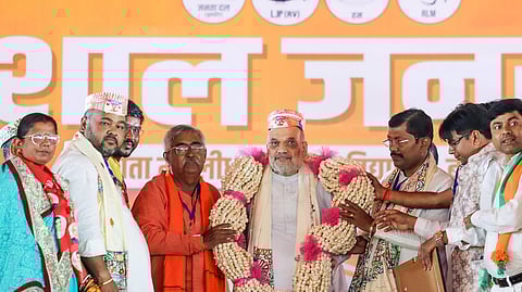 Union Home Minister Amit Shah being garlanded during a public rally for the second phase of the Bihar assembly elections, in Madhubani on Thursday.