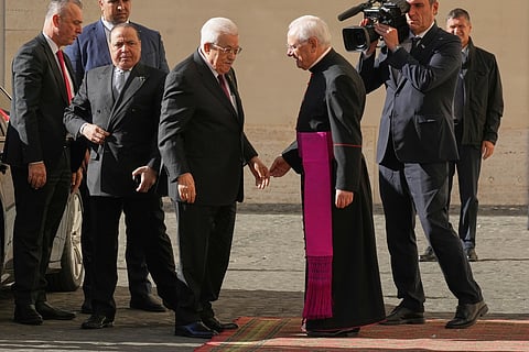 Palestinian President Mahmoud Abbas, also known as Abu Mazen, left, is welcomed by Monsignor Leonardo Sapienza as he arrives in the St. Damasus Courtyard at the Vatican for a meeting with Pope Leo XIV, Thursday, Nov. 6, 2025.