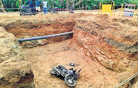 The bike which fell into the 8-foot-deep pit in Erode; (inset) Yoganathan