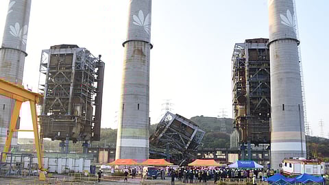 Rescue team work near a 60-meter (196-foot) tower which collapsed during demolition work at a decommissioned thermal power plant in Ulsan, South Korea, Thursday, Nov. 6, 2025.
