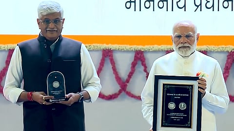 Prime Minister Narendra Modi, right, and Union Minister of Culture and Tourism Gajendra Singh Shekhawat release commemorative stamp during an event marking 150 years of the national song 'Vande Mataram', at the Indira Gandhi Indoor (IGI) Stadium, in New Delhi.