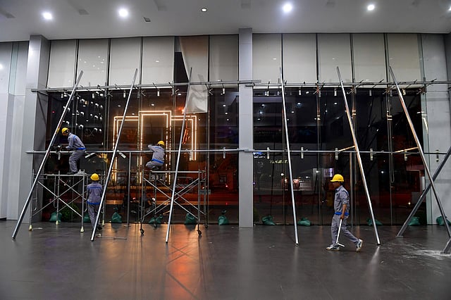 Workers reinforce glass walls with scaffoldings ahead of Typhoon Kalmaegi in Quy Nhon, Vietnam Wednesday, Nov. 5, 2025.